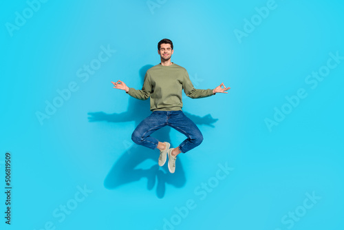 Full length portrait of calm meditating person closed eyes hands fingers isolated on blue color background