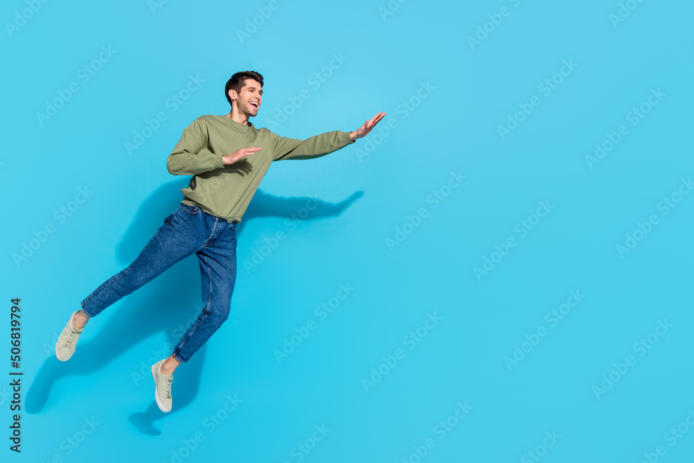 Full body photo of funny millennial brunet guy run wear shirt jeans sneakers isolated on blue background