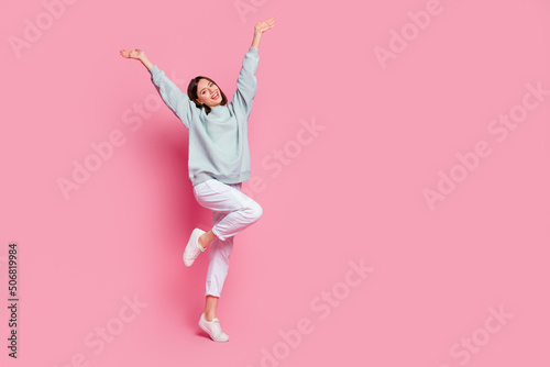 Full size photo of young lovely excited woman hands up rejoice glad isolated over pink color background