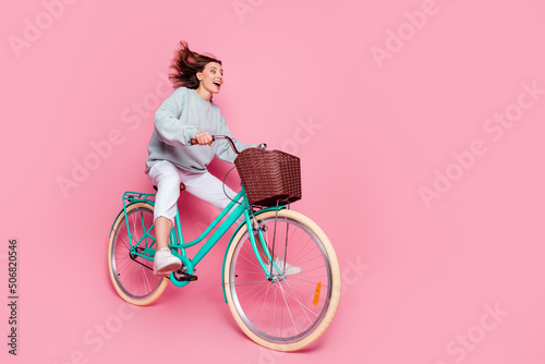 Fototapeta Naklejka Na Ścianę i Meble -  Full length profile side photo of young pretty woman good mood look empty space isolated over pink color background