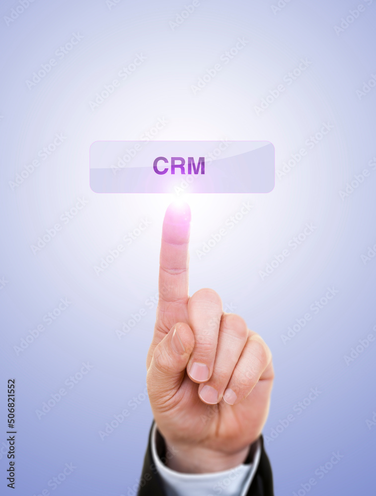 Businessman is Pushing On CRM Button Against Blue Businessman is Pushing On CRM Button Against Blue