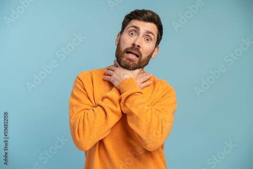 Bearded hoary man over isolated background shouting and suffocate because painful strangle. Health problem. Asphyxiate and suicide concept © NFstock