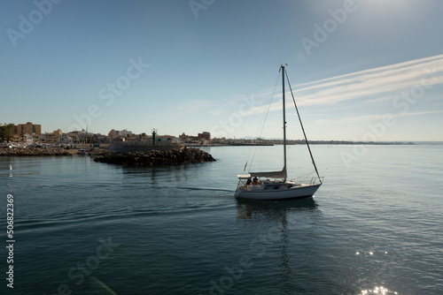 Palma de Mallorca, Spain, 2 October 2018. Sailboat leaving the port of Portixol, on a beautiful autumn morning with a serene sea and a blue sky.