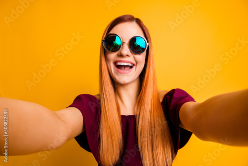 Photo of pretty positive person make selfie recording video toothy smile isolated on yellow color background