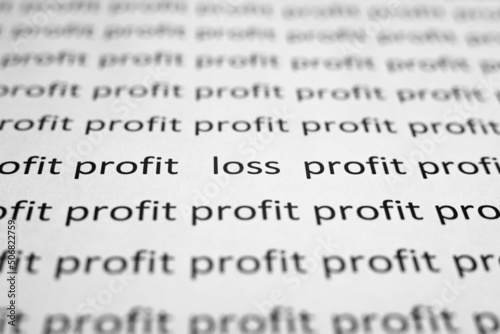 Financial problems, economic crisis concept. Printed text profit and loss on white paper close-up. Selective focus on word Loss, low angle view, macro photo