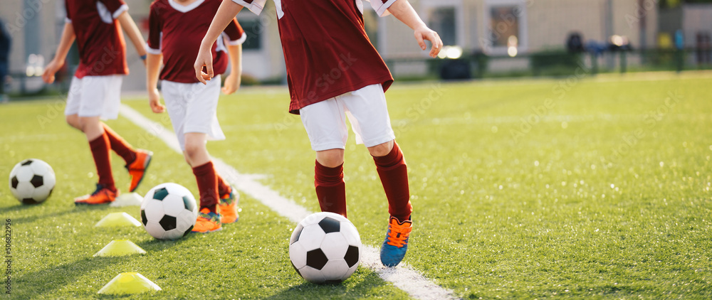 Kids Playing Soccer on Training Football Pitch. Sports Soccer Players on Training. Boys Kicking Soccer Balls on Practice Session. Beginner Soccer Drills for Juniors Kids Playing Soccer on Training Football Pitch. Sports Soccer Players on Training. Boys Kicking Soccer Balls on Practice Session. Beginner Soccer Drills for Juniors