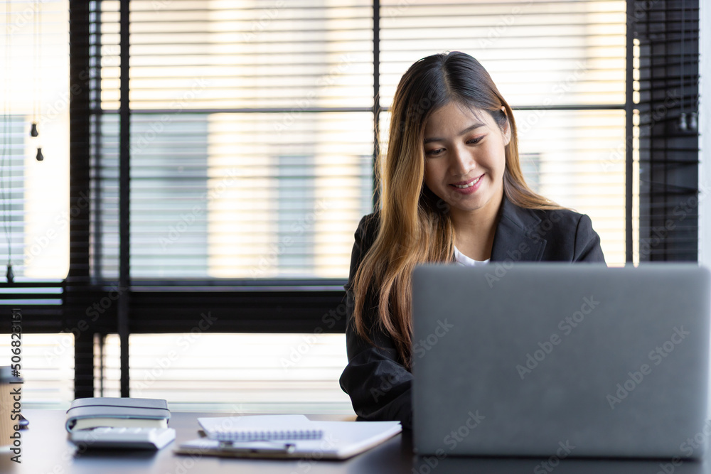 Businesswoman manager working on laptop in office. Businesswoman manager working on laptop in office.