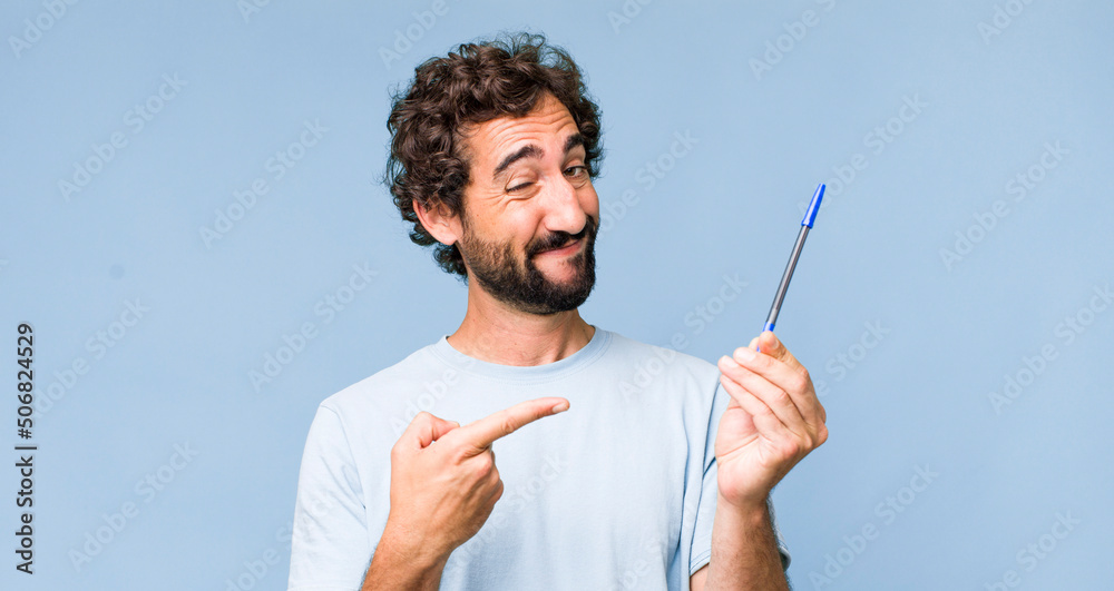 young adult hispanic crazy man with a pen - obrazy, fototapety, plakaty 