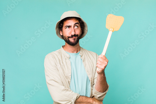 Canvas Print young adult hispanic crazy man with a fly swatter