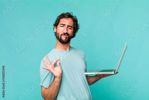young adult hispanic crazy man with a laptop