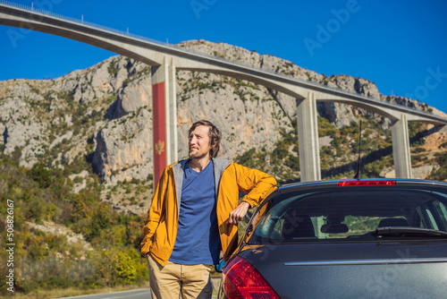 Montenegro. Man in the background of Bridge Moracica. Reinforced concrete bridge across the Moraci gorge. The motorway Bar - Bolyare. The bridge is on the Smokovac - Uvach - Mateshevo section. The photo