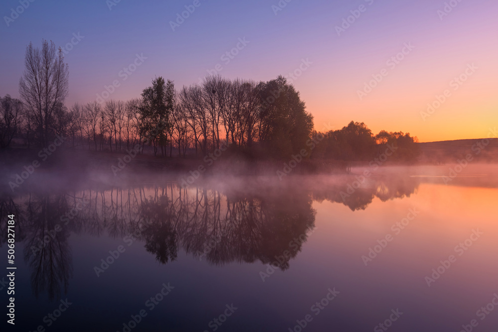 Morning on the lake early morning reeds mist fog and water surface reflection on the lake