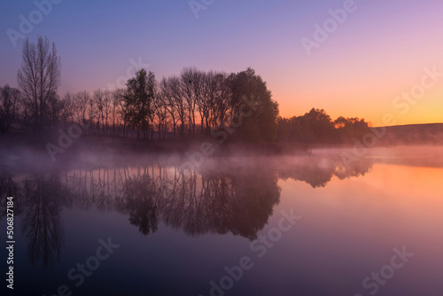 Morning on the lake early morning reeds mist fog and water surface reflection on the lake © welcomeinside