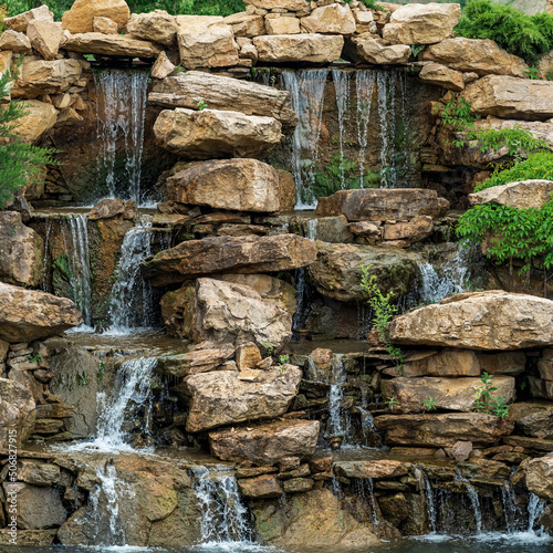 landscape design, a dam with a cascade of waterfalls in the form of natural rocks