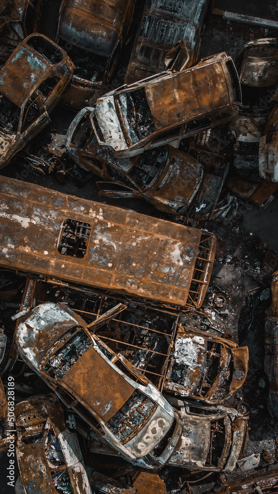 Irpin, Kyiv region, Ukraine - 19.05.2022 , a lot of burnt shelled cars in the parking lot, the consequences of the invasion of the Russian army in Ukraine. War in Ukraine. Drone photo