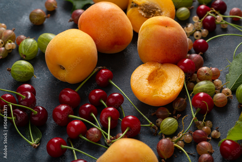Close up of cherry apricots and berries summer food background Close up of cherry apricots and berries summer food background