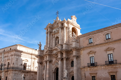 Scenic view on facade of Duomo Cathedral of Ortigia (Ortygia) in Syracuse (Siracusa), Sicily, Italy, Europe. Historic city center of Piazza del Duomo, UNESCO World Heritage Site. Mediterranean flair