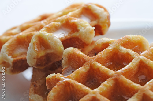 Two waffles with syrup