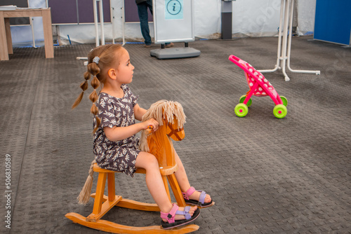 Potsdam, Germany 22 mai 2022: A child near the Tent on the Red Cross Society, volunteer assistance for refugees from Ukrina photo