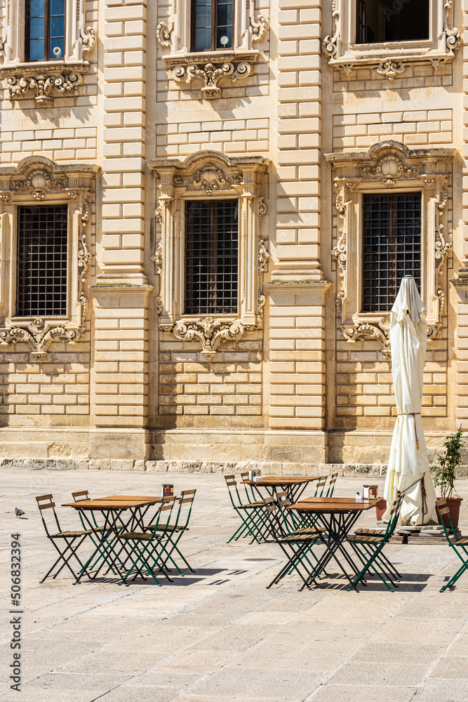 Empty tables of a closed coffee shop in the main baroque square of Lecce, Apulia Italy