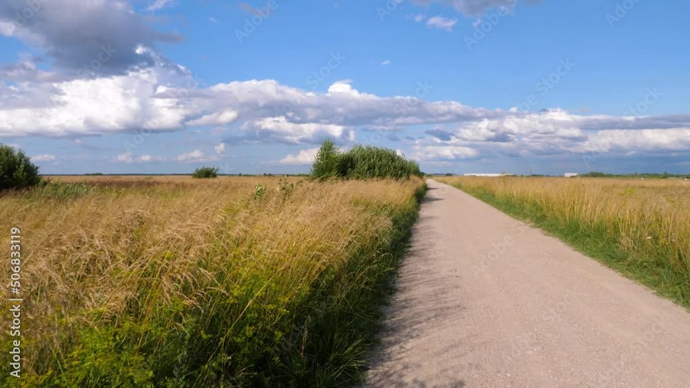 First person view walking on gravel country road on sunny summer day. First person view walking on gravel country road on sunny summer day.