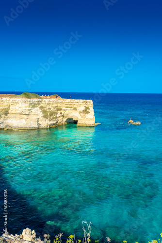 SALENTO, ITALY, 11 AUGUST 2021 The beautiful crystal clear Sea of Apulia from the cliffs and the sea stacks of Sant'Andrea