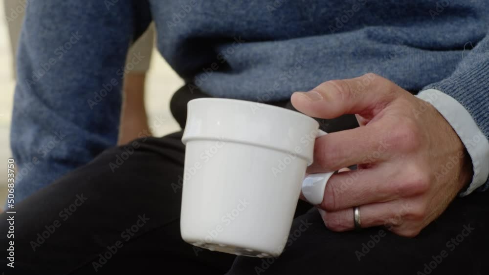 Middle aged man holding coffee cup drinking close up hold hand hands office space working worker job break lunch colleagues discussing conversation conversing wrist hot drink talking men listening Middle aged man holding coffee cup drinking close up hold hand hands office space working worker job break lunch colleagues discussing conversation conversing wrist hot drink talking men listening