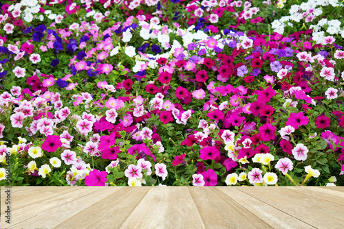 Empty top wooden table on soft blurred colorful flowers