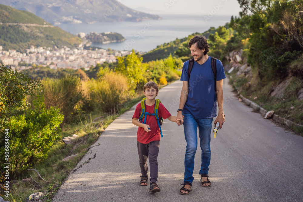 Happy family on the background of Panoramic view of the city of Budva, Montenegro. Beautiful view from the mountains to the Adriatic Sea Happy family on the background of Panoramic view of the city of Budva, Montenegro. Beautiful view from the mountains to the Adriatic Sea