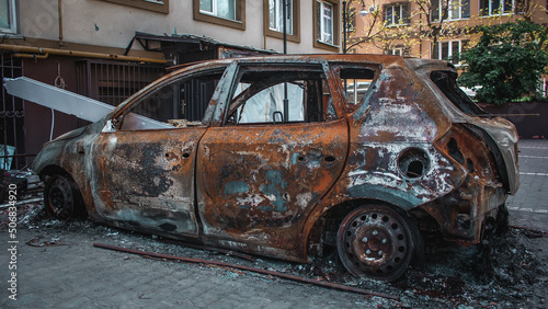 Irpin, Kyiv Oblast, Ukraine - 19.05.2022: Cities of Ukraine after the Russian occupation. burnt civilian car in city of Irpin, northwest of Kyiv