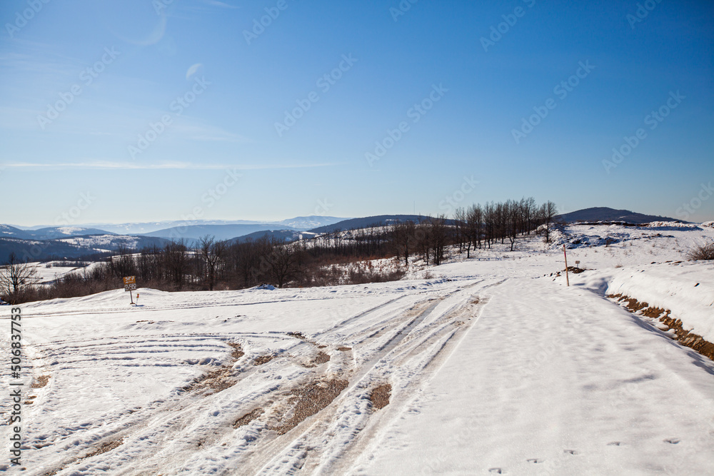 Winter nature landscape. Snow-covered fields and hills. Beautiful winter sunny day. Rural landscape.	
