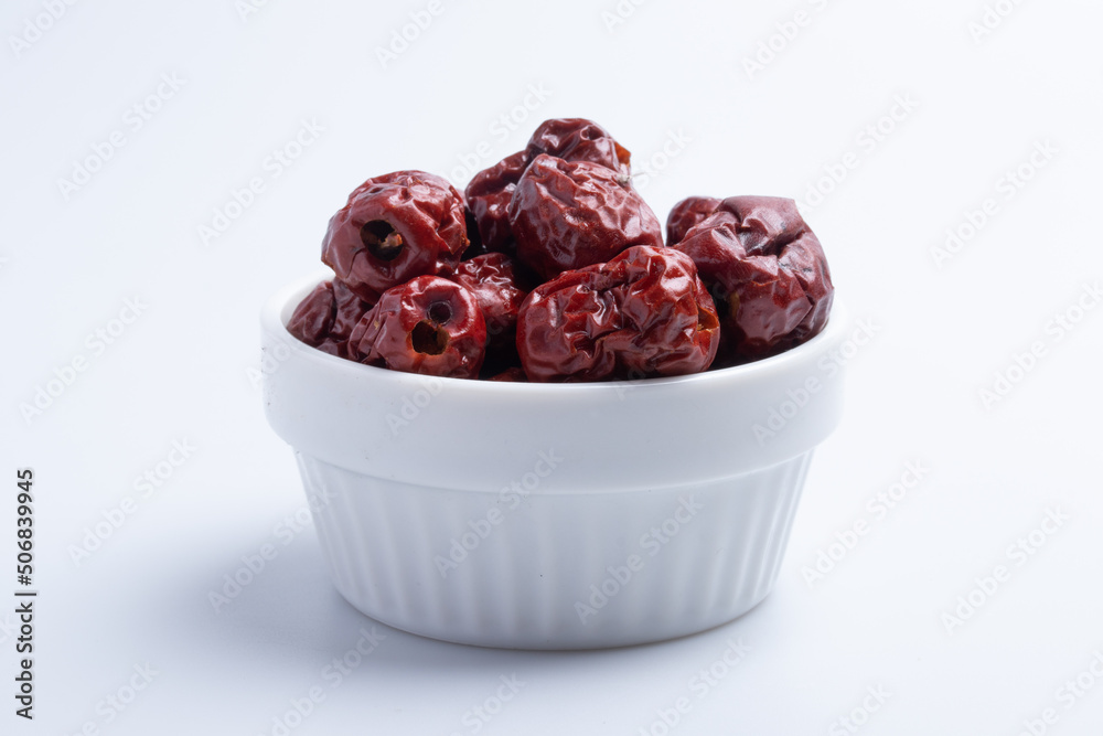 Dried Chinese jujube in a cup on white background. Isolated image.