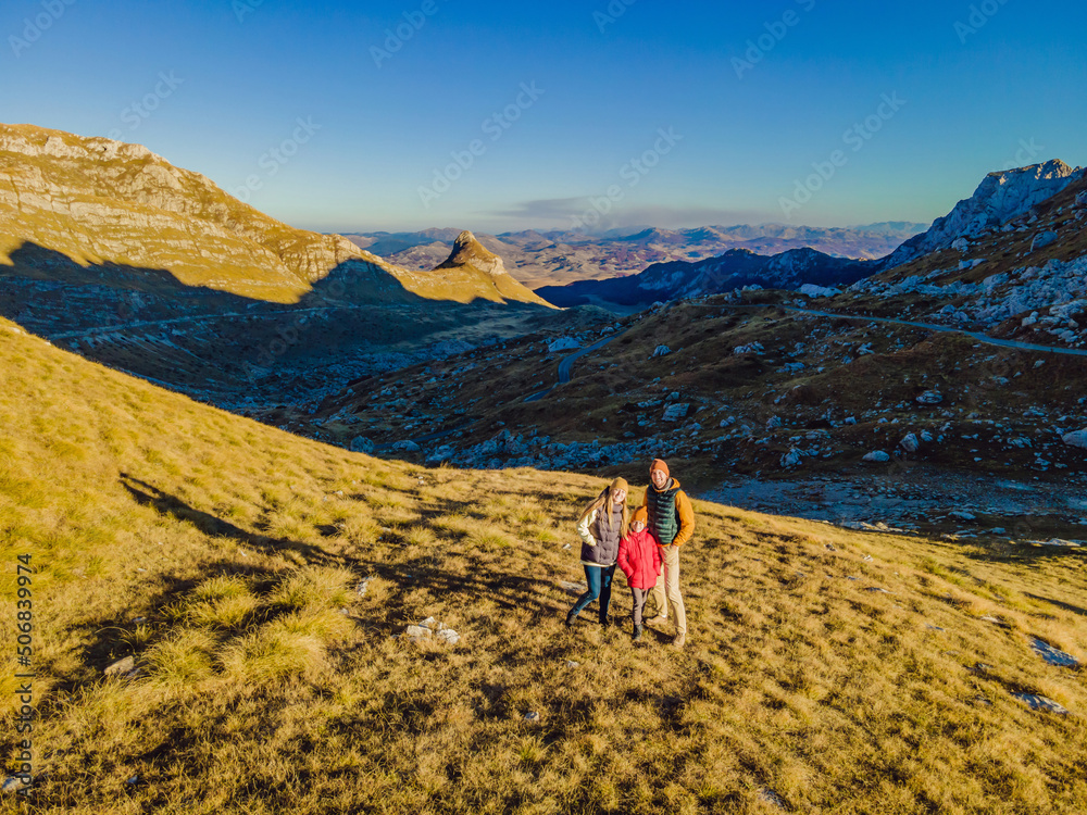 Montenegro. Happy family of tourists on the background of Durmitor National Park. Saddle Pass. Alpine meadows. Mountain landscape. Travel around Montenegro concept