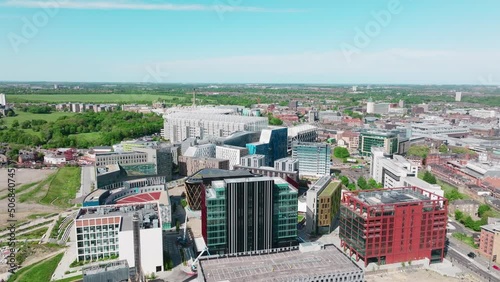 Former factories converted into state-of-the-art buildings including a cinema in Newcastle's Leazes area with in the background the football stadium St James Park on a sunny day. Drone lowering shot photo