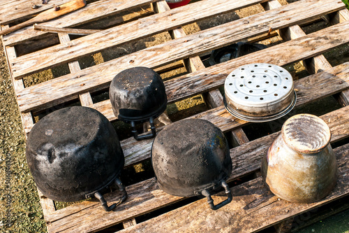 Old vintage fire pots and mortar on wood in Nongbualamphu province ,Thailand