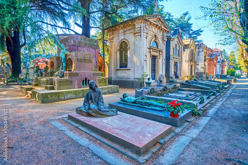 The line of the graves with sculptures, Monumental Cemetery in Milan, Italy photo