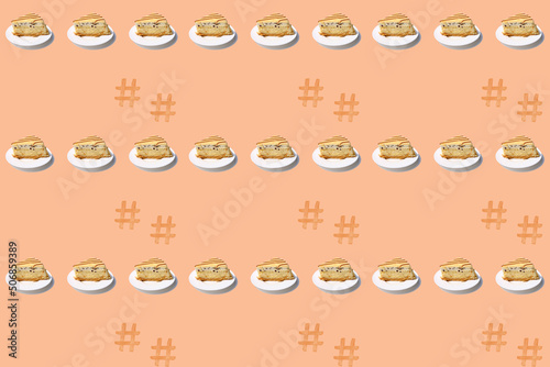 seamless texture  pattern with piece of biscuit cake with chocolate  cream  marzipan on white plate  isolated peach background  calorie sweets concept  unhealthy food  homemade baking for wallpaper
