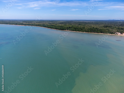 Amazing paradisiacal and deserted beach with clear blue waters and visible corals at low tide - Cumuruxatiba, Bahia, Brazil - aerial drone view