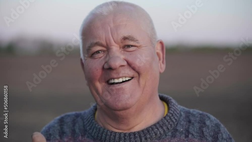 Portrait of a smiling senior adult man who looking into the camera. The pensioner enjoys life. Cheerful sincere emotion of elderly people. Wrinkled face of an old peasant.The concept of happy old age
