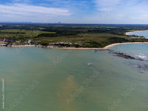 Amazing paradisiacal and deserted beach with clear blue waters and visible corals at low tide - Cumuruxatiba, Bahia, Brazil - aerial drone view