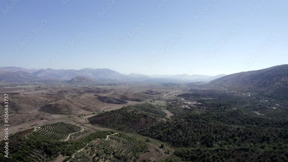 Video with drone advancing over the plain of the interior of Albania in Saranda, Dry, sunny weather and drought predominates in nature, Descriptive frontal plane video. Video with drone advancing over the plain of the interior of Albania in Saranda, Dry, sunny weather and drought predominates in nature, Descriptive frontal plane video.