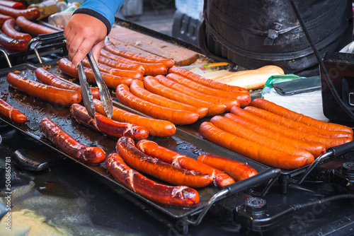Photography Grilled sausages bring prepared at Brick Lane market in London