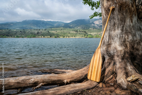 wooden canoe paddle on a shore of mountain lake - Horsetooth Reservoir in northern Colorado