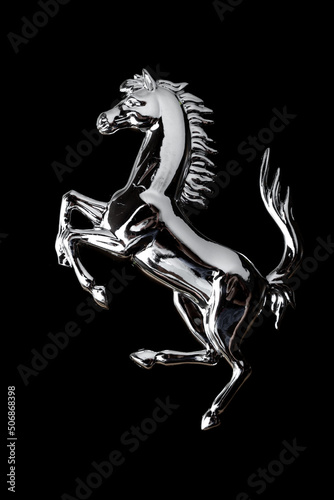 Metal horse on black background..