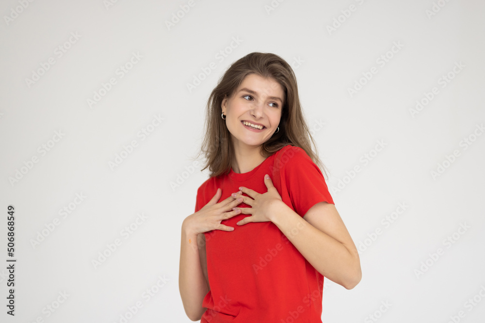 Portrait of a happy smiling beautiful woman posing with hand in hair against gray background Portrait of a happy smiling beautiful woman posing with hand in hair against gray background