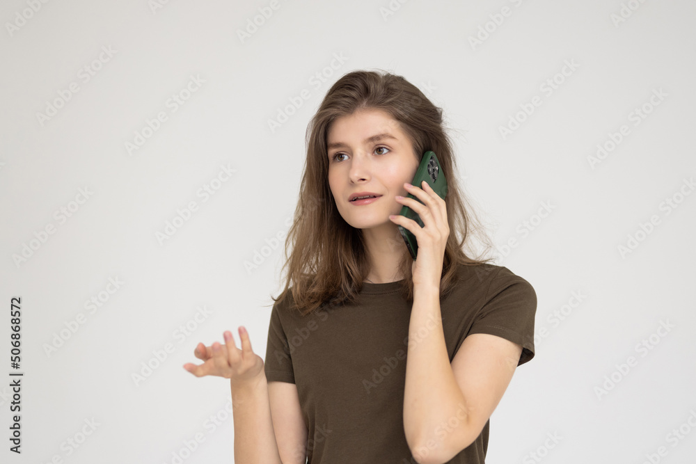 Beautiful business woman talking on the mobile phone and smiling, isolated on white Beautiful business woman talking on the mobile phone and smiling, isolated on white