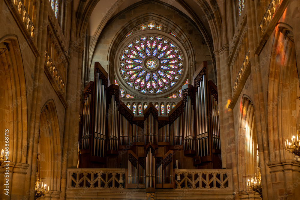 close-up horizontal plan of the organ next to the stained glass windows and columns of Bilbao Cathedral in Spain
