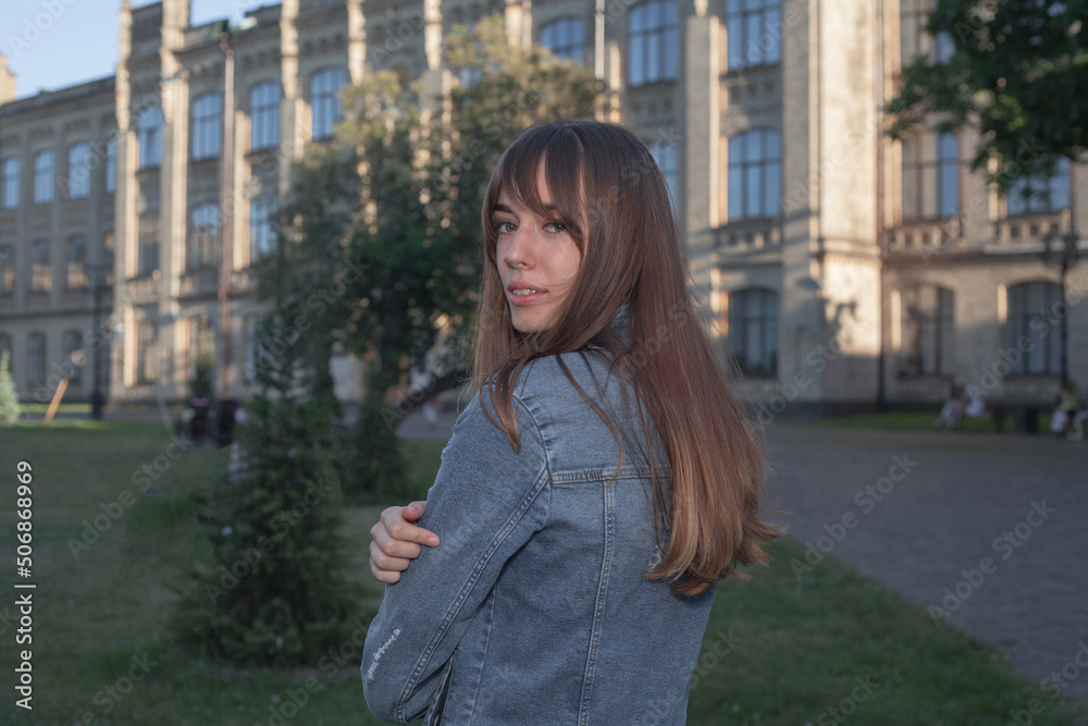 Fototapeta premium Young cute girl walking in city park