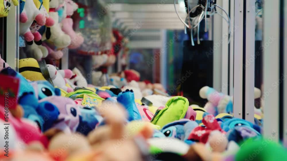 Grabber machine with lovely dolls inside. Amuse dolls in crane claw machine cabinet. Grabber machine with lovely dolls inside. Amuse dolls in crane claw machine cabinet.
