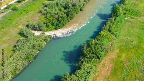 Aerial view on the sewage discharges that take place in the Tiber river, in Italy. Water changes color in contact with urban waste of Rome. photo